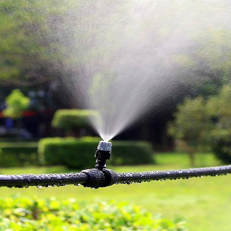 Automatische beregening besproeit het gazon van een tuin in het Gooi